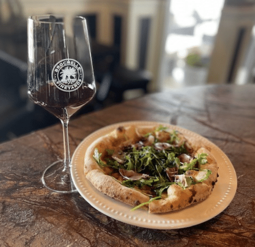 Glass of Brochelle wine with personal pizza